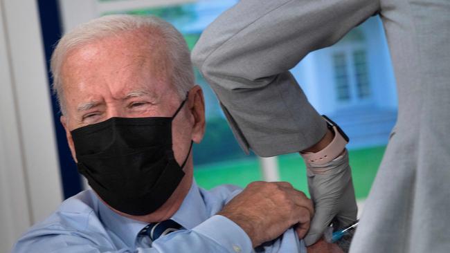 Joe Biden receives a third shot of the Pfizer vaccine in Washington on Monday. Picture: AFP