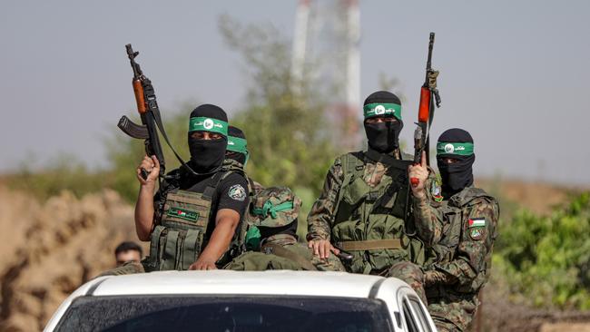 Palestinian fighters from the military wing of Hamas take part in a military parade near the border with Israel. Pixture: Getty