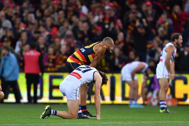 Crows and Power players stiop on the final siren on the Round 7 match at Adelaide Oval on Sunday . Pictuire: David Mariuz/AAP