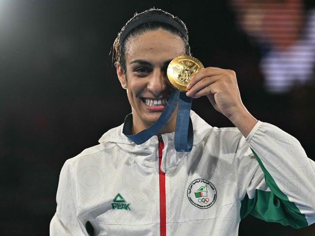 TOPSHOT - Gold medallist Algeria's Imane Khelif poses on the podium during the medal ceremony for the women's 66kg final boxing category during the Paris 2024 Olympic Games at the Roland-Garros Stadium, in Paris on August 9, 2024. (Photo by MOHD RASFAN / AFP)