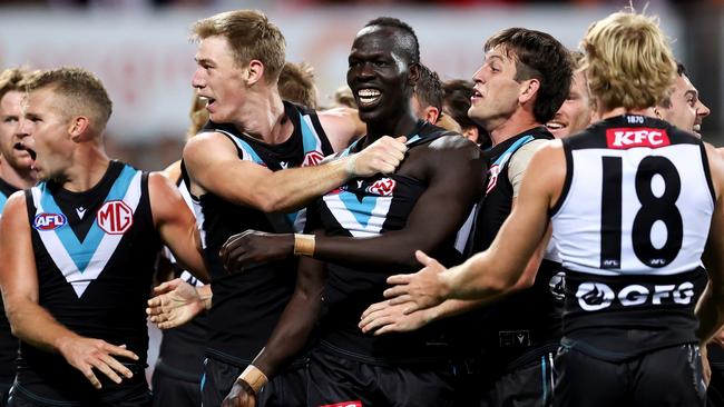 SYDNEY, AUSTRALIA - APRIL 08: Aliir Aliir of Port Adelaide celebrates with team mates at full time during the round four AFL match between Sydney Swans and Port Adelaide Power at Sydney Cricket Ground, on April 08, 2023, in Sydney, Australia. (Photo by Brendon Thorne/AFL Photos/via Getty Images )