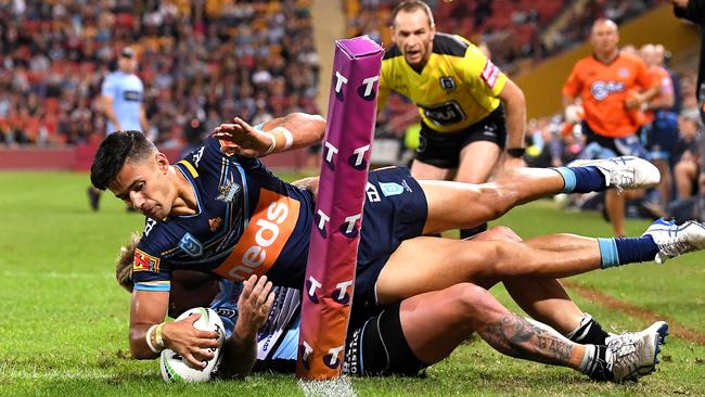 BRISBANE, AUSTRALIA - MAY 09: Jesse Arthars of the Titans is taken over the sideline as he attempts to score a try during the round nine NRL match between the Gold Coast Titans and the Cronulla Sharks at Suncorp Stadium on May 09, 2019 in Brisbane, Australia. (Photo by Bradley Kanaris/Getty Images)