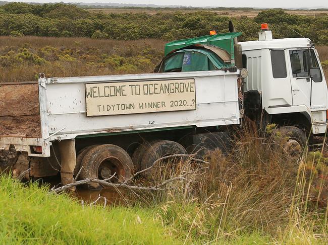 An abandoned truck now has humorous sign attached "Welcome to Ocean Grove" Tidytown winner 2020..?" after hurtling into the State Game Reserve mangroves off Wallington Road. Picture: Alan Barber