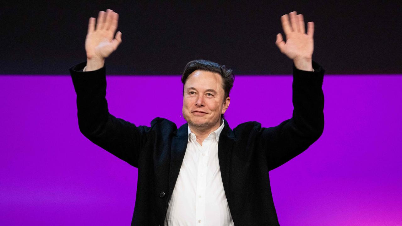 Tesla chief Elon Musk waving onstage at the TED2022: A New Era conference in Vancouver, Canada. Picture: AFP photo / TED conferences / Ryan Lash