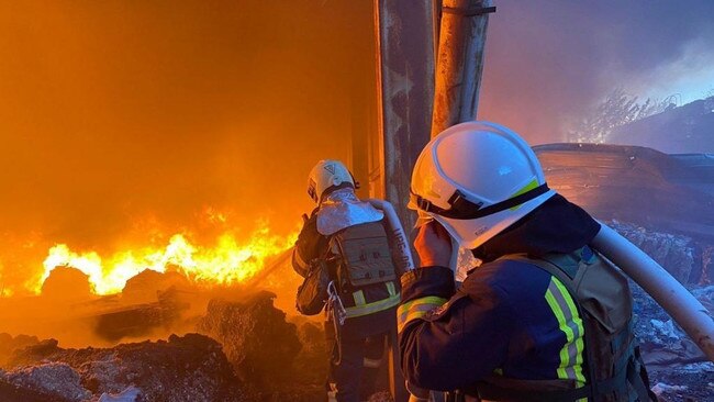 Firefighters attend the site of a Russian missile strike in Kyiv on Monday. Picture: Getty Images