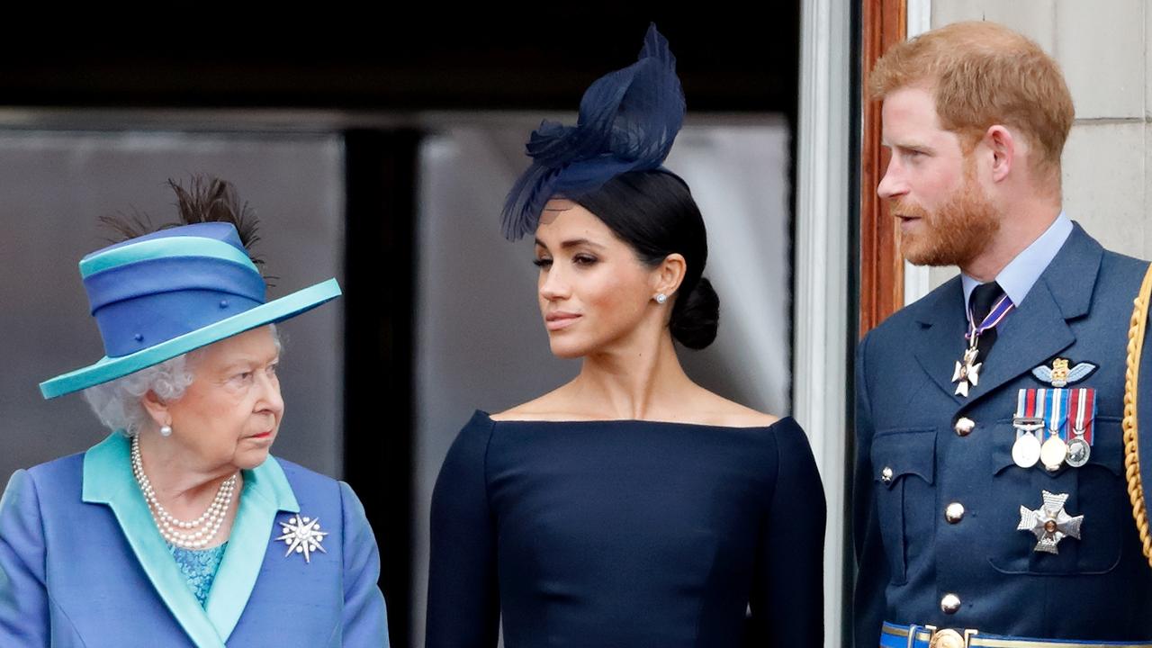 Queen Elizabeth II, Meghan, Duchess of Sussex and Prince Harry, Duke of Sussex watch a fly-past to mark the centenary of the Royal Air Force from the balcony of Buckingham Palace on July 10, 2018. Picture: Max Mumby/Indigo/Getty Images