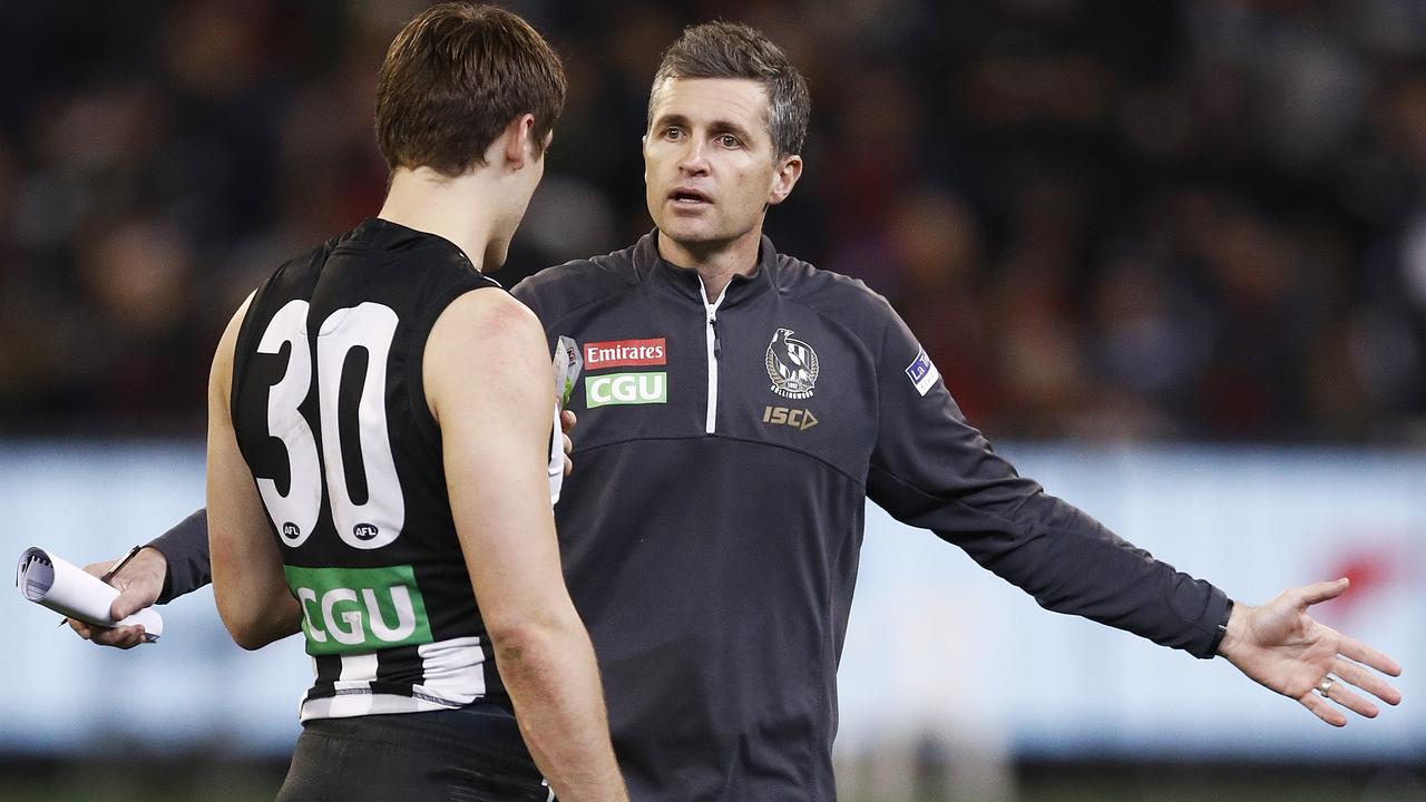 MELBOURNE, AUSTRALIA — AUGUST 23: Magpies assistant coach Justin Longmuir (R) speaks with Darcy Moore of the Magpies during the round 23 AFL match between the Collingwood Magpies and the Essendon Bombers at Melbourne Cricket Ground on August 23, 2019 in Melbourne, Australia. (Photo by Daniel Pockett/Getty Images)