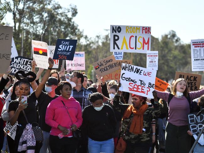 Black Lives Matter protesters march in front of Parliament House in Canberra, Friday, June 5, 2020. The protesters were demonstrating aboriginal deaths in custody and the death of George Floyd in the United States. (AAP Image/Mick Tsikas) NO ARCHIVING