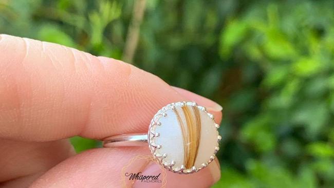 A ring made with breast milk and locks of hair from three children made by Annie Cooper of Whispered Memories.
