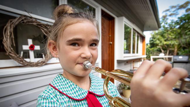 Taylor Grayson (11) pictured playing her trumpet on the balcony at her home in Avalon. Picture: Julian Andrews.