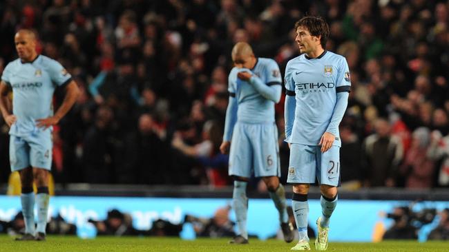 Manchester City's Spanish midfielder David Silva (C) reacts.