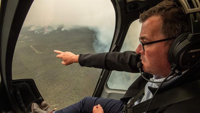 Fuel load issue: Victorian Premier Daniel Andrews, pictured flying over the Gippsland fires has used arson asa reason not to release fuel-load maps. Picture: Jason Edwards