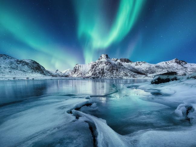 Aurora Borealis, Lofoten islands, Norway. Mountains and frozen ocean. Winter landscape in the night time. Northen light - image