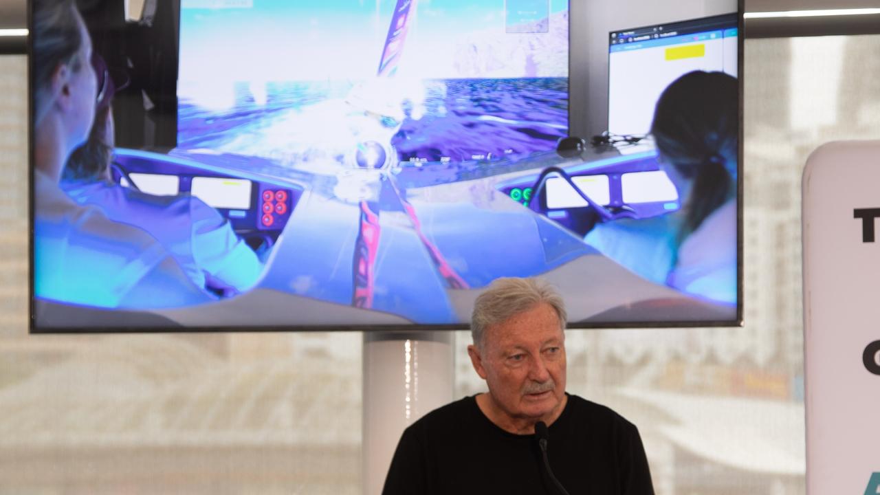 John Bertrand with simulator footage in the background at the launch off the Australia's youth and women's America's Cup Challenge squad. Picture: Nicole Douglas