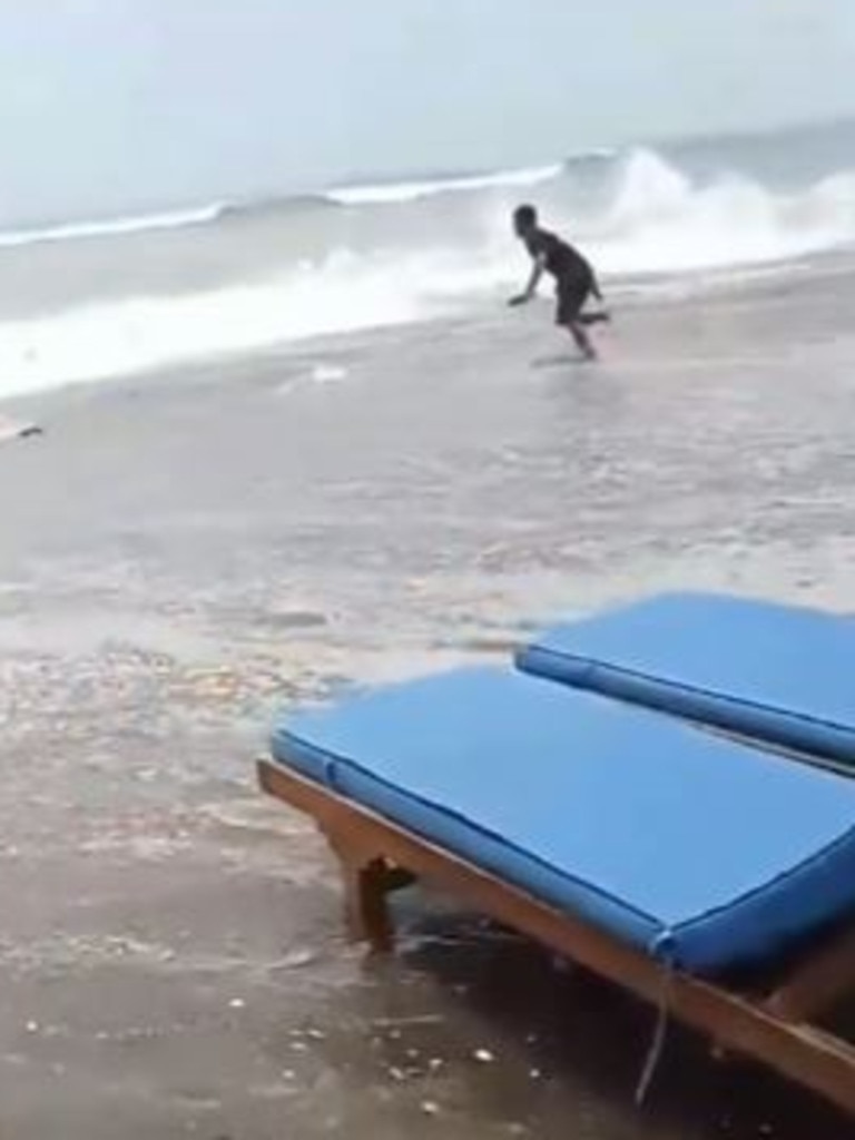 The moment a wave surge hit Seminyak Beach.