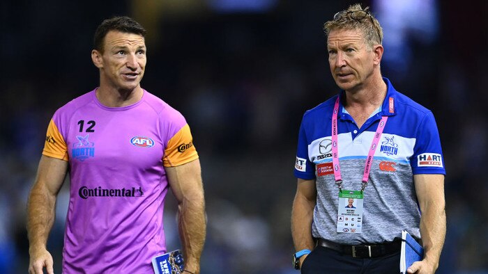 MELBOURNE, AUSTRALIA - APRIL 02: Brent Harvey and Kangaroos head coach David Noble walk off the field after losing the round 3 AFL match between the North Melbourne Kangaroos and the Western Bulldogs at Marvel Stadium on April 02, 2021 in Melbourne, Australia. (Photo by Quinn Rooney/Getty Images)