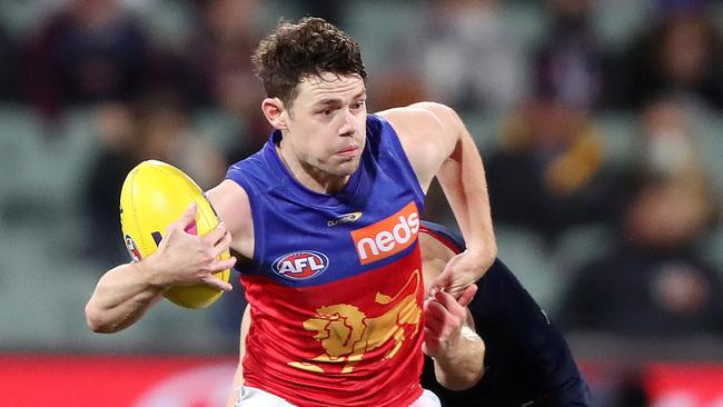 ADELAIDE, AUSTRALIA – AUGUST 28: Lachie Neale of the Lions tries to break the tackle of Jack Viney of the Demons during the 2021 AFL First Qualifying Final match between the Melbourne Demons and the Brisbane Lions at Adelaide Oval on August 28, 2021 in Adelaide, Australia. (Photo by Sarah Reed/AFL Photos via Getty Images)