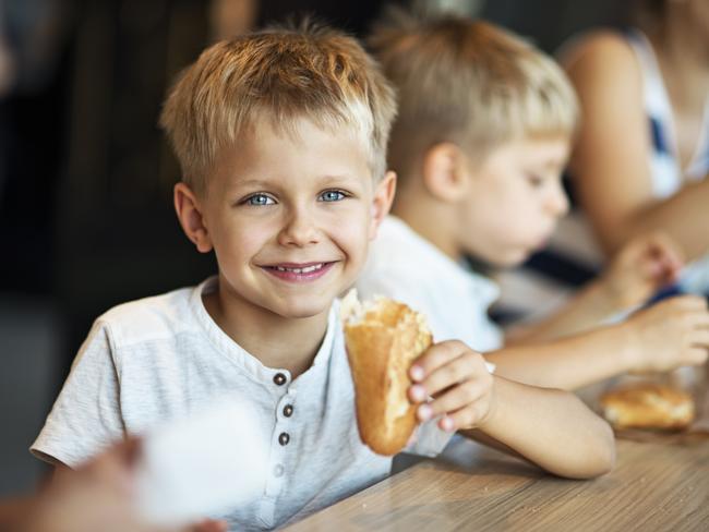 istock little boy eating generic for GC Eye best child friendly cafes.