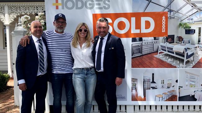 Hodges agents Carl Hammond, left, and Marcus Falconer and their vendors put a sold sticker up outside 45 Waratah St, Geelong West, on Saturday.