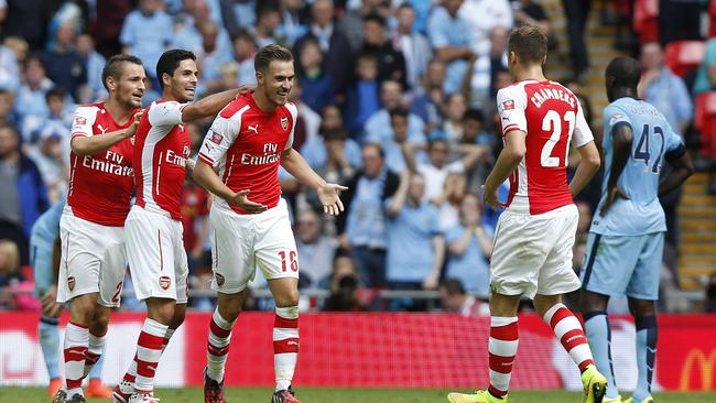 Arsenal's Aaron Ramsey, third left, celebrates his goal against Manchester City with teammates.