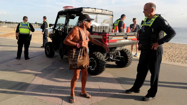 Police move beach goers on after closing St Kilda Beach. Picture: David Geraghty