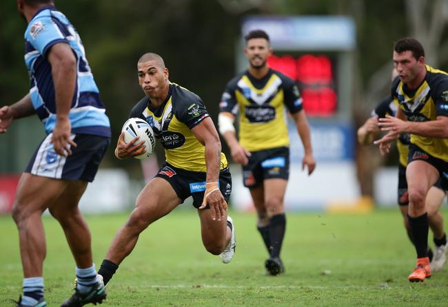 Sage Wilder avoiding a Cabramatta opponent in the Ron Massey Cup kick-off.