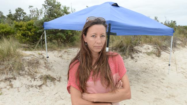 Kelly Winsor with one of many marquees left discarded on Peninsula beaches. Picture: Chris Eastman