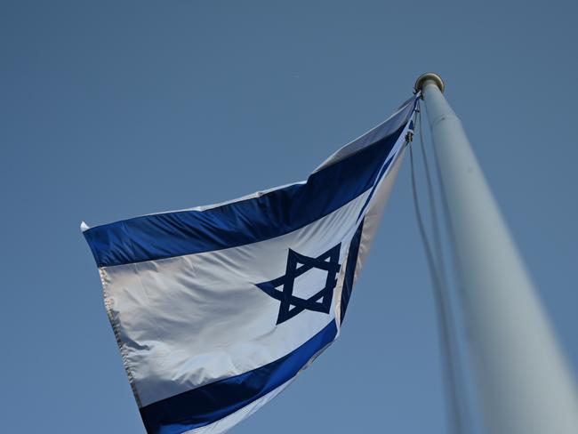 CANBERRA, Australia - NewsWire Photos - October 7, 2024: October 7th vigil at the Israeli Embassy in Canberra.  Flag of Israel. Picture: NewsWire / Martin Ollman