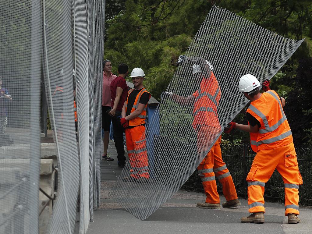 Workers build a fence around Winfield House, ahead of the State Visit by US President Donald Trump, in London. Picture: AP Photo/Frank Augstein