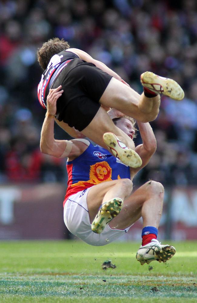 Troy Selwood collides with Essendon’s Kyle Hardingham in his final game in 2010. Picture: AAP Image/David Crosling.