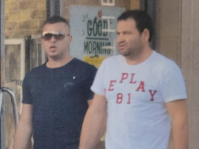 The courier (left), Ibrahim Yavuz (centre in sunnies and black shirt) and Alfred Kola (right in white shirt) leave Flight Centre at Mawson Lakes in May 2014bafter purchasing the courier flights to Panama.