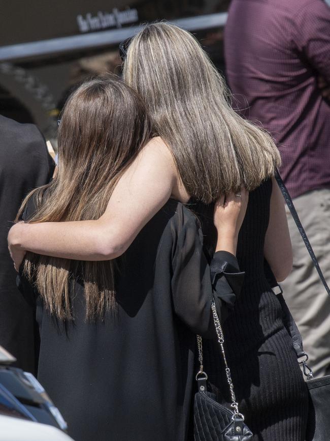 Mourners share a hug at Antonio Desisto’s service. Picture: NCA NewsWire / Simon Bullard