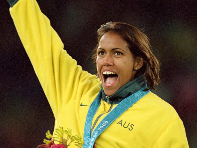 25 Sep 2000:  Cathy Freeman of Australia on the podium celebrating gold in the Womens 400m Final at the Olympic Stadium on Day 10 of the Sydney 2000 Olympic Games in Sydney, Australia.  \\ Mandatory Credit: Stu Forster /Allsport