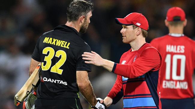 Glenn Maxwell is congratulated by England captain Eoin Morgan after the match. Picture: AFL Photo