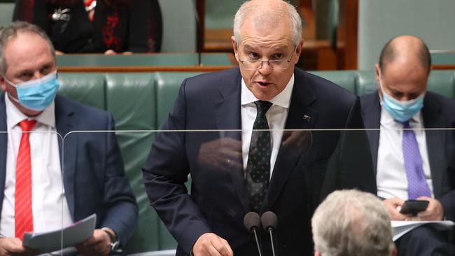 Opposition in front of him, rebels behind … Scott Morrison during question time. Picture: Gary Ramage