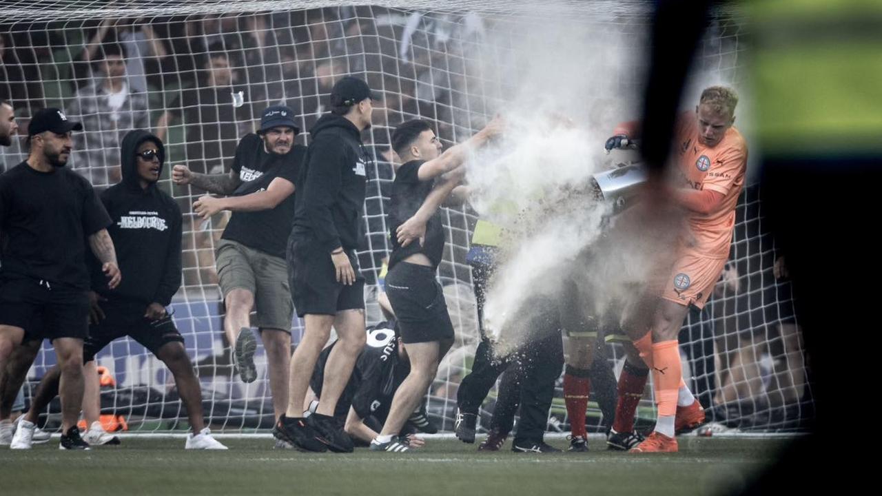 Fans attack Melbourne City goalkeeper Tom Glover.