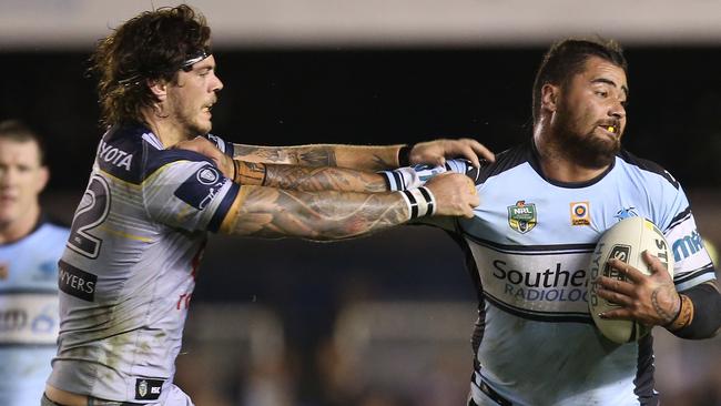 Andrew Fifita of the Sharks (right) fends off a tackle from Ethan Lowe of the Cowboys during the round 14 NRL match between the Cronulla-Sutherland Sharks and the North Queensland Cowboys at Southern Cross Group Stadium in Sydney on Monday, June 13, 2016. (AAP Image/Craig Golding) NO ARCHIVING, EDITORIAL USE ONLY