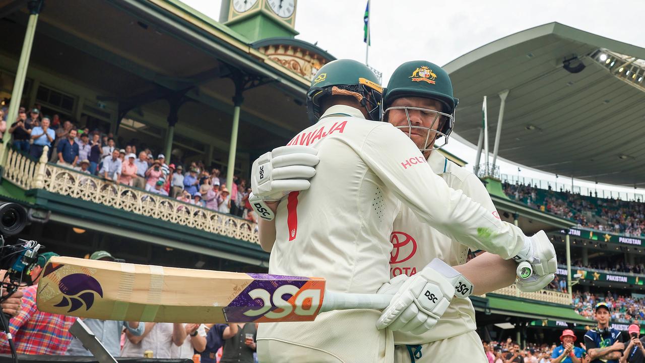 David Warner and Usman Khawaja embrace before walking out to bat on day one. picture: Getty