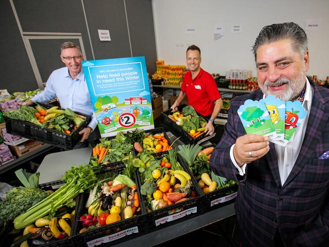 SecondBite board member Matt Preston launches Coles’ winter appeal with the help of SecondBite CEO Jim Mullan, left, and Coles' Thinus Keeve. Picture: supplied