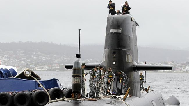 Out with the old ... a Collins Class Submarine, HMAS Farncomb, arrives in Hobart.