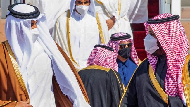 Crown Prince Mohammed bin Salman (R) welcoming Emir of Qatar Tamim bin Hamad Al-Thani (L) upon his arrival in the city of al-Ula in northwestern Saudi Arabia.