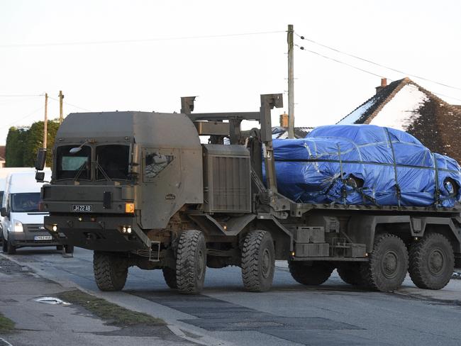 A vehicle wrapped in blue tarpaulin is removed from Larkhill Road in Durrington, 16 kilometres north of Salisbury, England. Picture: AP