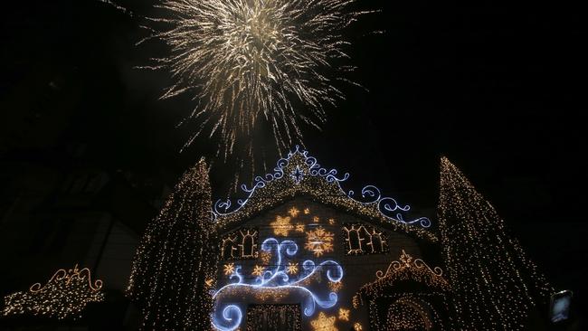 Fireworks illuminate the sky over an elaborately decorated house in the run up to the new year in Belgrade.