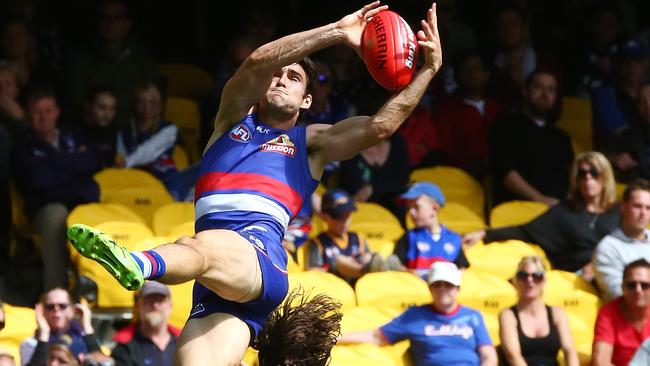 AFL: Round 1 , Western Bulldogs V Fremantle at Etihad Stadium, 27th March, Melbourne Australia. Western Bulldogs Easton Wood takes a mark in the third quarter over Fremantle's Lachie Weller Picture : George Salpigtidis