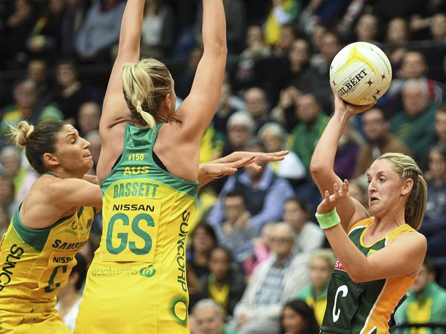 Erin Burger of South Africa (right) fights for the ball with Caitlin Bassett (centre) and Kim Ravaillion of Australia during the Netball Quad Series game between the Australian Diamonds and the South Africa Spar Proteas at the AIS Arena in Canberra, Wednesday, August 30, 2017. (AAP Image/Lukas Coch) NO ARCHIVING, EDITORIAL USE ONLY