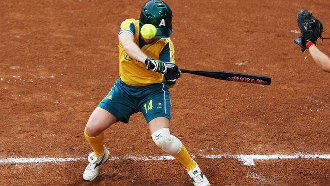 Kerry Wyborn takes one on the helmet in the Japan-Australia softball game in Beijing Picture: Brett Costello