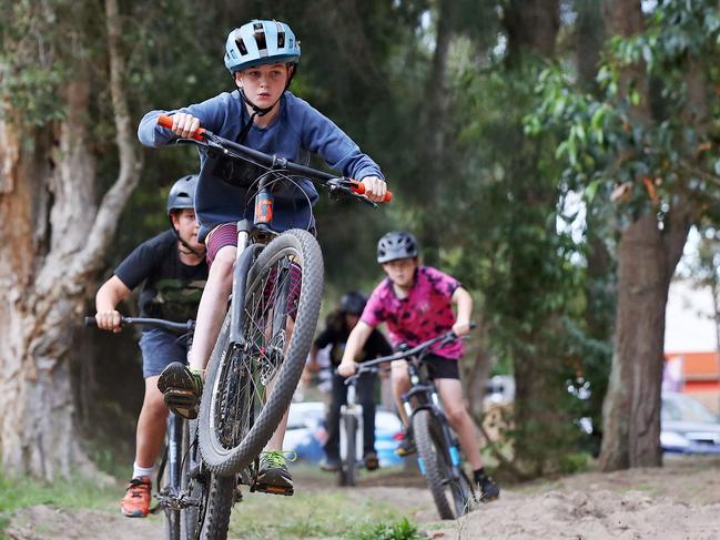 Kids around the Sutherland Shire area have been spending weeks building and playing at bike jumps in local parks only for council to pull them down. Riley Kenna 13 pictured with his mates at their local bmx track they built in Caringbah. Picture: Toby Zerna