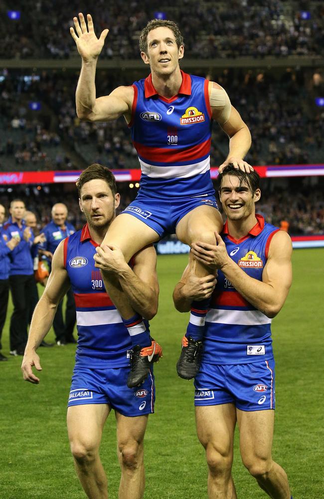 Bob Murphy is chaired off by Matthew Boyd and Easton Wood. Picture: Wayne Ludbey