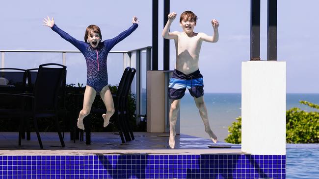 Tourism Tropical North Queensland is encouraging more tourists to visit the Far North in Summer, typically a quiet time of the year with rain and high temperatures deterring visitors. Cousins Ruby Blackwell, 6, and Tim Blackwell, 9, jump into the resort pool at Vue Trinity Beach while visiting Cairns from Sydney. Picture: Brendan Radke