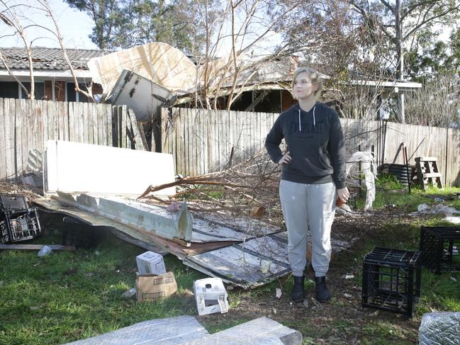 Neighbour Keileigh Ferguson inspects the damage to her back yard after the truck hit the house next-door. AAP Image / Mark Scott